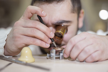Close up portrait of a watchmaker at work