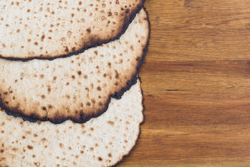 Matzot for passover celebration on a wooden table