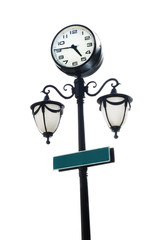 Black lamppost with round clock and green copy space signage iso