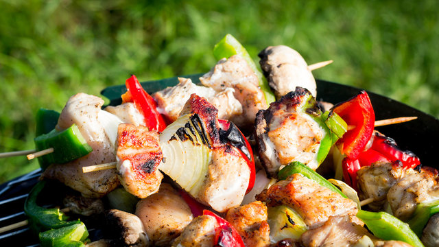 Grilling shashlik on barbecue grill