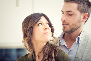 young couple look each other in the kitchen