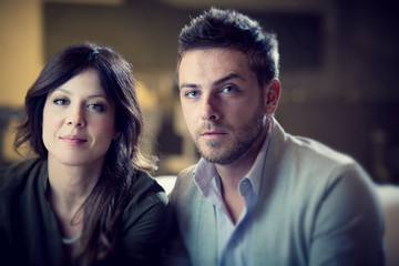 young casual couple flirt in the living room