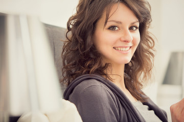 young smiling brunette girl relax in her bedroom