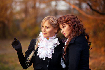 two beautiful young girls in autumn forest