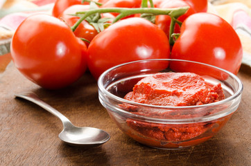 tomato paste in a glass bowl and spoon