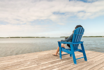 Fototapeta na wymiar Woman relaxing seated near the ocean