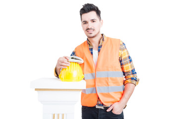 Handsome constructor or engineer standing near workwear equipmen