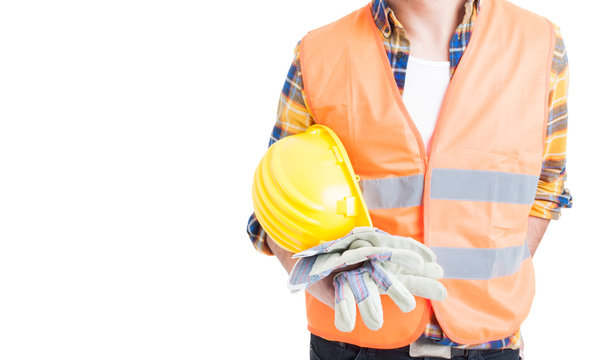 Closeup engineer holding helmet and wearing vest and gloves