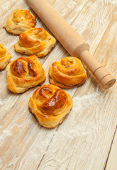 wheat buns, rolls with cinnamon, rolling-pin, meal on the table