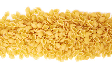 Line made of dry conchiglie pasta over isolated white background