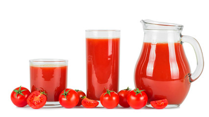 Tomato juice in glasses and fresh tomatoes .