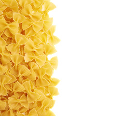 Pile of dry farfalle pasta over isolated white background