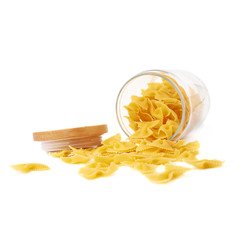Glass jar filled with dry farfalle pasta over isolated white background