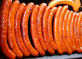 Sausages baked on iron plate in row party time