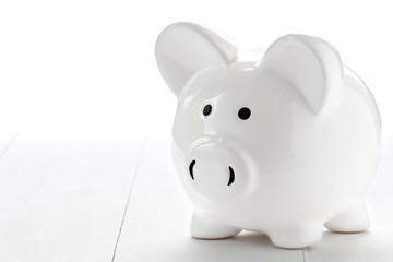 Piggy bank on white wooden floor