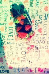 group of strawberries inside a glass, love style