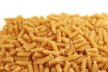 Pile of dry rotini pasta over isolated white background