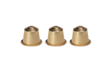 Three golden Nespresso capsules, tasty Italian espresso