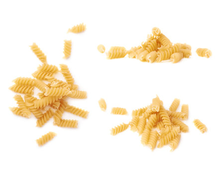 Pile of dry pasta rotini over isolated white background