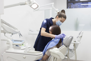 Beautiful woman patient having dental treatment at dentist's office. Woman visiting her dentist