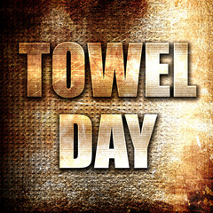 towel day, written on vintage metal texture