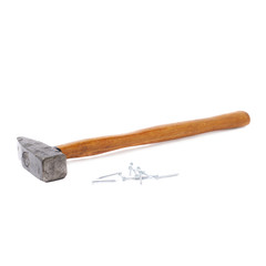 Big hammer with pile of nails over white isolated background