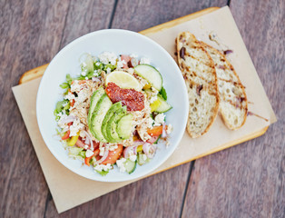 Healthy salad with chicken, avocado and sundried tomat