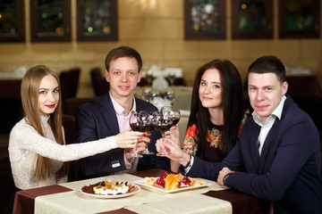 Friends at a restaurant drinking wine.