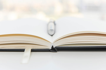 Notebook is opening with pen on top