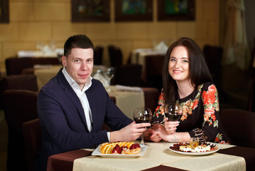 Couple toasting wineglasses in a luxury restaurant