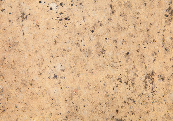 Brown stone wall tile seamless background and texture..