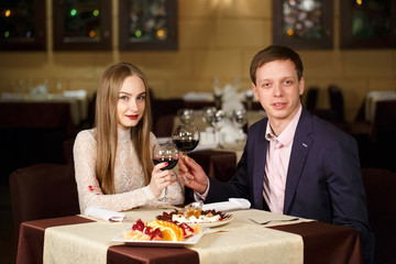 Couple toasting wineglasses in a luxury restaurant.