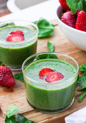 Green spinach smoothie with strawberry