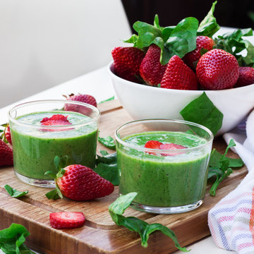 Green spinach smoothie with strawberry