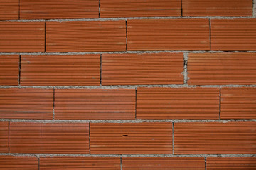 Orange bricks background - new wall texture, site under construction