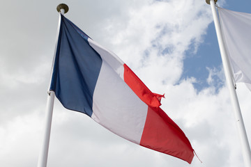 Flag of France over a blue and cloudy sky