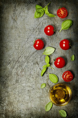 Cherry tomatoes with basil leaves and olive oil