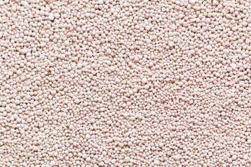 Pink background with mineral fertilizers balls.