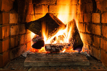 burning wood in fire-box of fireplace