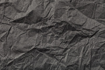 background from black crumpled paper