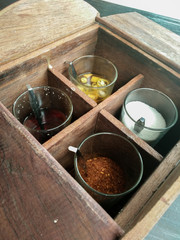 Condiment Set Sugar, vinegar, cayenne pepper and fish sauce for Thai noodle or padthai in wood box