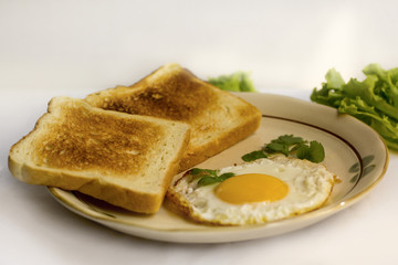 healthy breakfast fried egg yellow yolk, toast bread, sausage, vegetable in morning,  delicious sandwich diet lunch