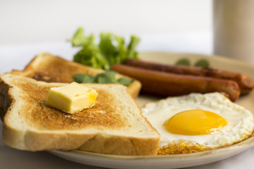 healthy breakfast fried egg yellow yolk, toast bread, sausage, vegetable in morning,  delicious sandwich diet lunch