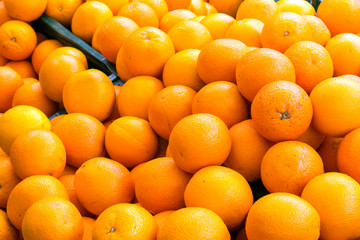 A pile of oranges for sale at a market
