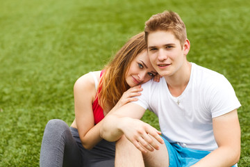 young sport people sitting on the grass