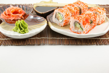 Japanese seafood sushi rolls with chopstick wasabi and ginger