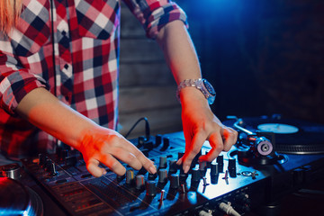 Cute dj woman having fun playing music at club party