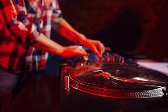 Cute dj woman having fun playing music at club party