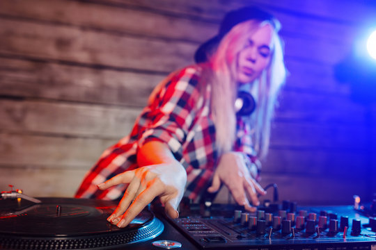 Cute dj woman having fun playing music at club party