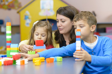 Kids and Educator Playing at Kindergarten